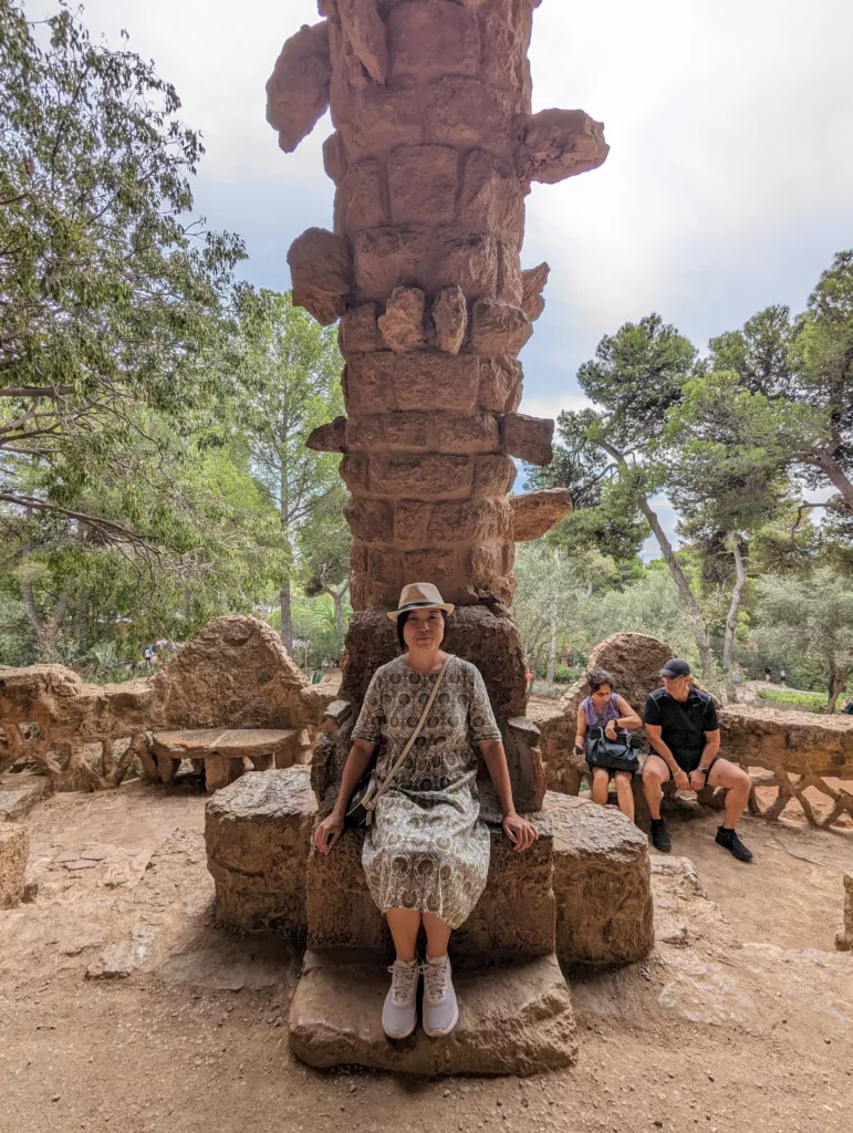 Sachie sitting before a column