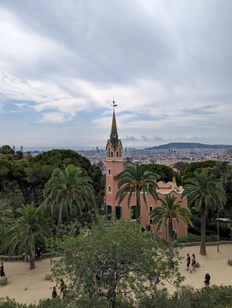 Wide view of church, trees and city skyline looking towards the sea
