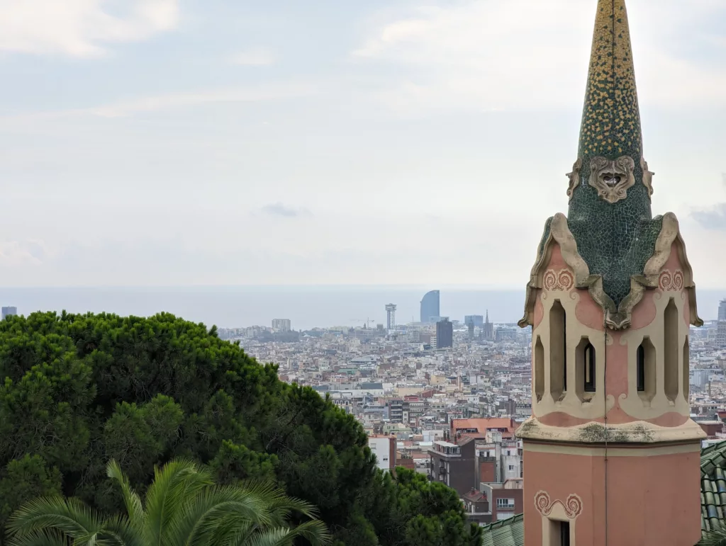 Church spire with city and sea in the background
