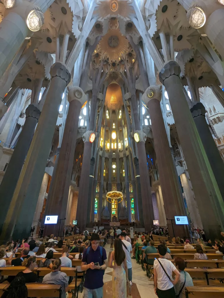 Looking down the pews of the interior of the Sagrada Familiar