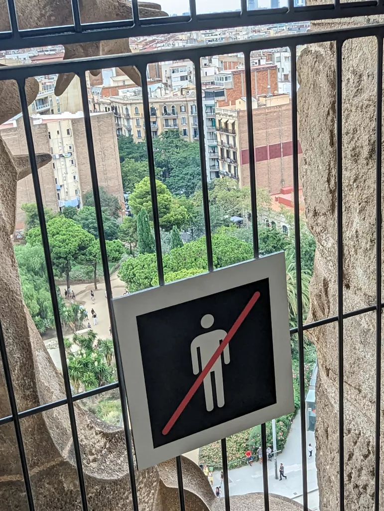 View out barred window with sign of man symbol struckthrough