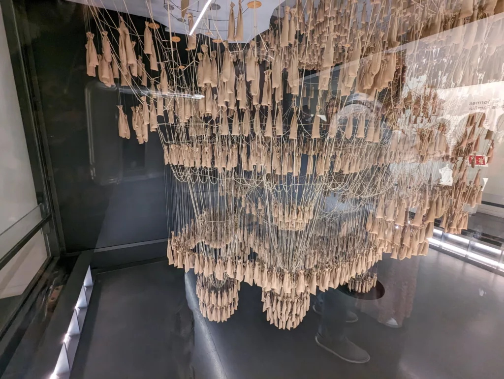 Inverted building model made of string and sand bags