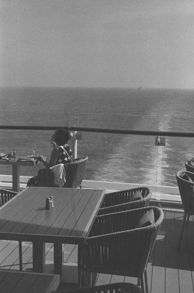 Sachie drinking prosecco and ship's wake