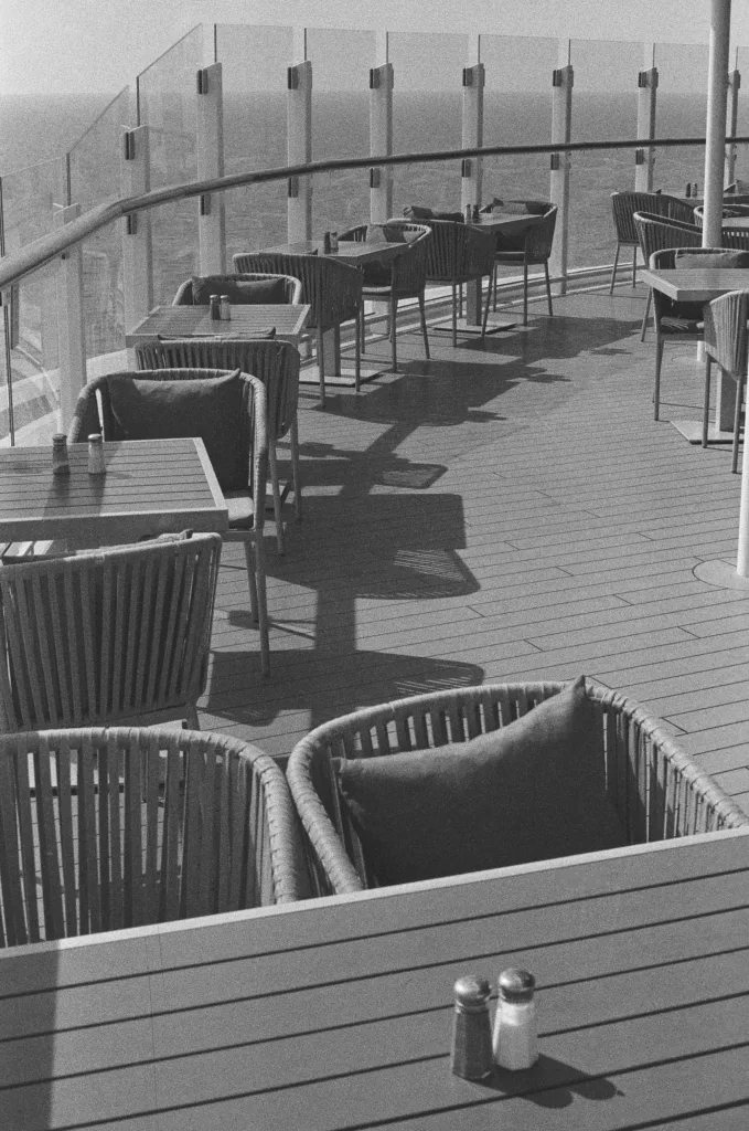 Cafe tables and chairs at end of ship