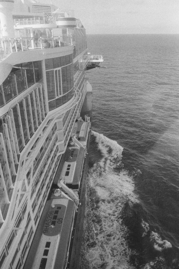 B&W photo of the side of the ship, looking forward