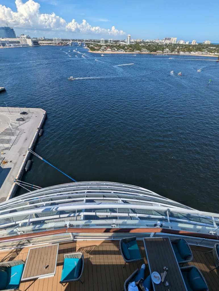 View of water and boats from stern of ship.