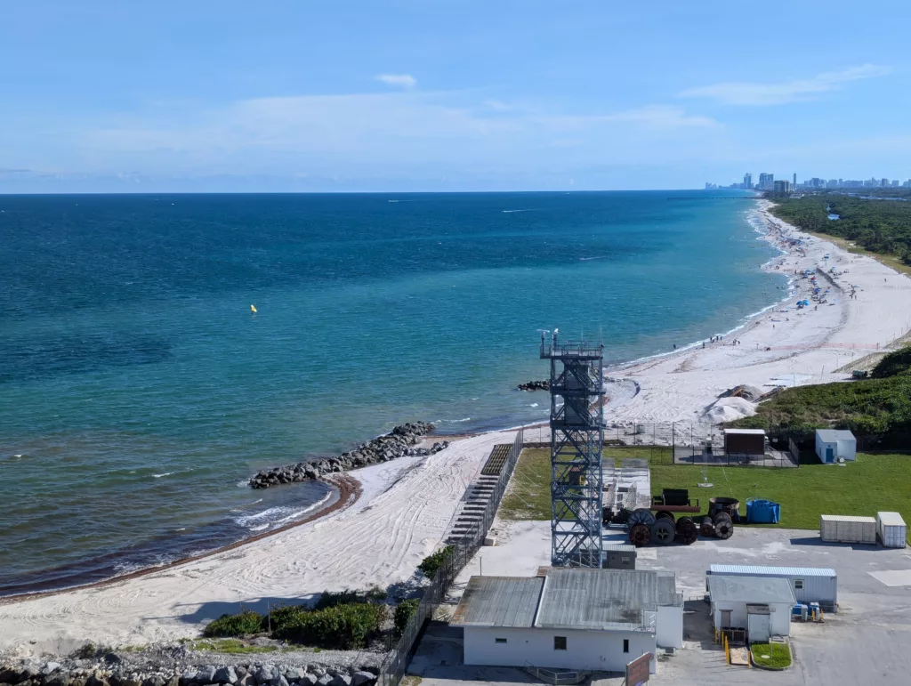 View down barrier island beach and coastguard station.