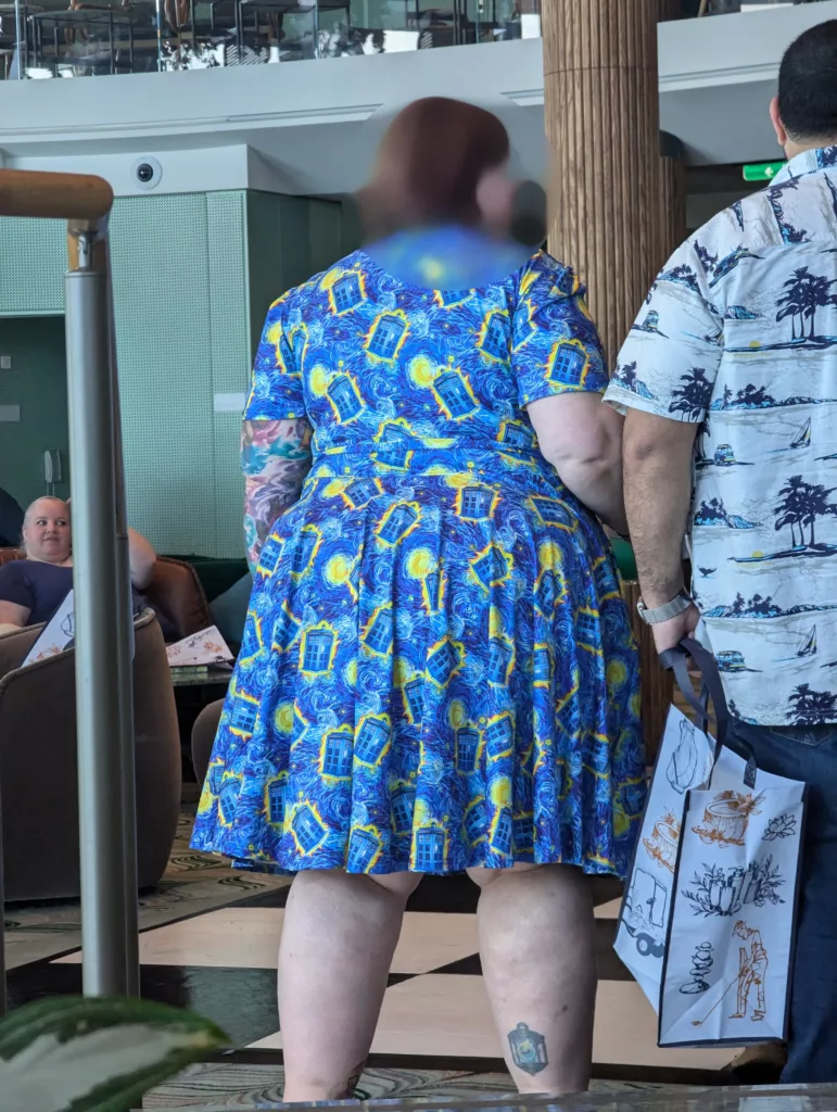 Large woman with Tardis print dress with face blurred