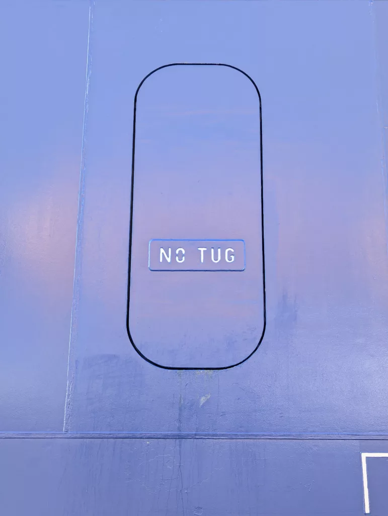 No Tug, painted on the side of the ship